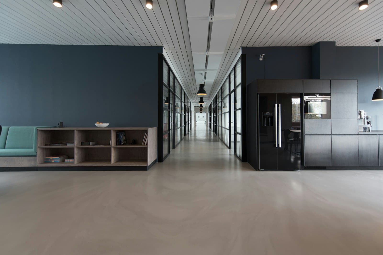 Clean, modern commercial corridor with glass partitions
